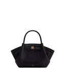 Black pebbled mini tote bag with flared sides, a single top handle, white contrast stitching, and a gold-toned rectangular bu