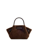 Dark brown faux fur mini tote bag with a single smooth dark brown top handle and smooth dark brown straps cinching its sides.