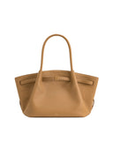 Light brown pebbled leather-like medium tote bag with a single top handle. Side straps cinch the bag with gold-toned hardware