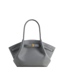 Grey pebbled leather tote bag with two top handles, a gold-toned clasp on a front strap, and white contrast stitching.