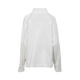 White long-sleeve women’s top with high neckline and metallic stud detailing, minimalist elegant design on a clean white background.