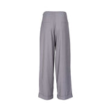 Grey wide-leg tailored trousers with high waist, front pleats, cuffed hems, and a clean minimalist finish, photographed on a white background.