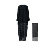 A Back view, high-end black abaya by JIJIL featuring a smooth matte top and a textured lower half with 3D floral embroidery, shown alongside a matching sheer black headscarf against a white background.