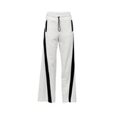JIJIL white women’s jogger trousers with black side stripes, elastic waistband, and relaxed fit, photographed on a white background.