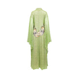 Lime green sequin-covered kaftan dress with wide sleeves and a stand-up collar. Large cream and beige leaf-like embroidery on