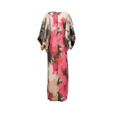 Maxi dress with a vibrant floral print in pink, black, and cream, featuring wide sleeves and metallic thread detailing.