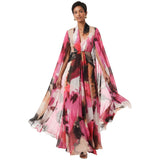 Pink, black, and beige floral print maxi dress with a V-neck, twisted waist, and flowing cape sleeves.