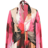 Abstract print dress with draped high collar, V-neck, long sleeves, knotted waist, and sequined side details.