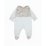 Front view of a Jules & Juliette Paris white babygrow for infants, featuring a pink floral print chest panel, a ruffled collar, and floral-patterned feet.
