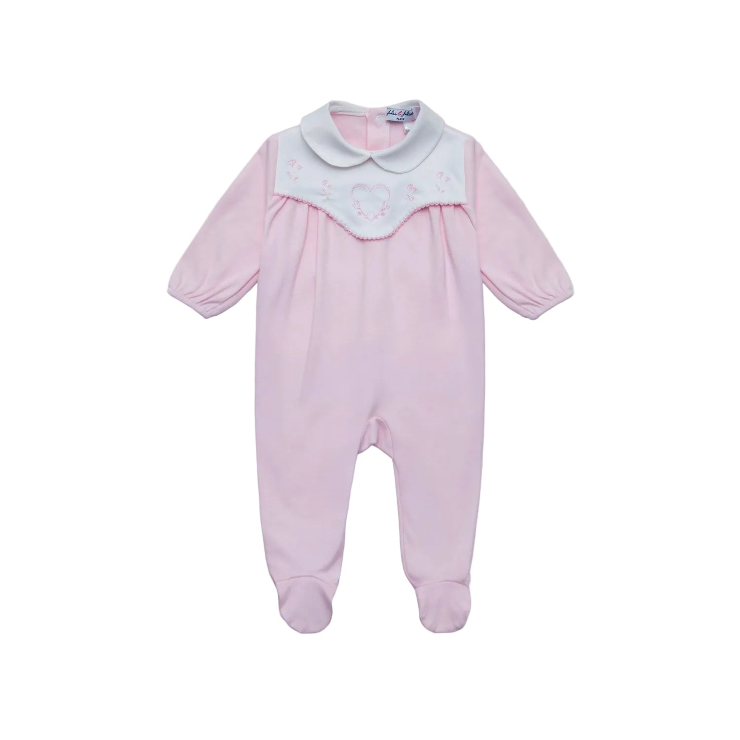 Front view of a Jules & Juliette Paris light pink babygrow featuring a white embroidered heart panel on the chest and a classic Peter Pan collar.