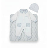 A three-piece luxury baby gift set by Jules & Juliette Paris in white and blue. The set includes a white footed romper with a blue striped collar and elephant embroidery, a matching white and blue elephant-patterned blanket, and a simple white beanie hat.