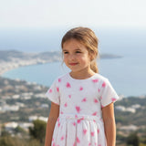 Close-up of the ivory jacquard fabric showing the embossed texture and the detailed pink butterfly motifs.