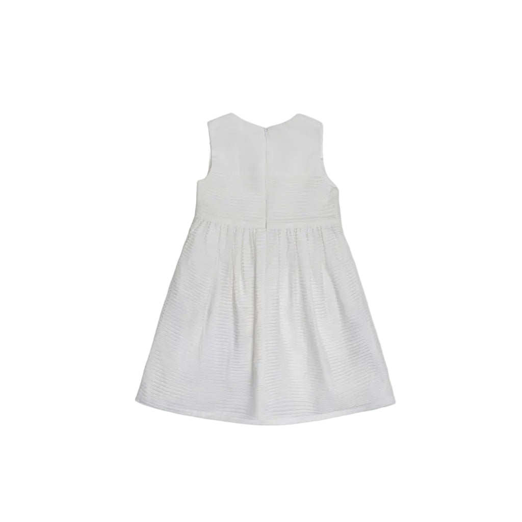 Back view of a white pleated sleeveless dress for girls showing the clean round neckline and concealed zipper closure.