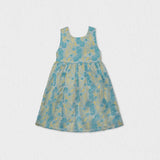 Front view of a Jules & Juliette Paris girls' sleeveless off-white jacquard dress featuring a metallic green pattern and a gathered skirt.