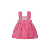 Pink dress with a subtle pattern on a light gray background.