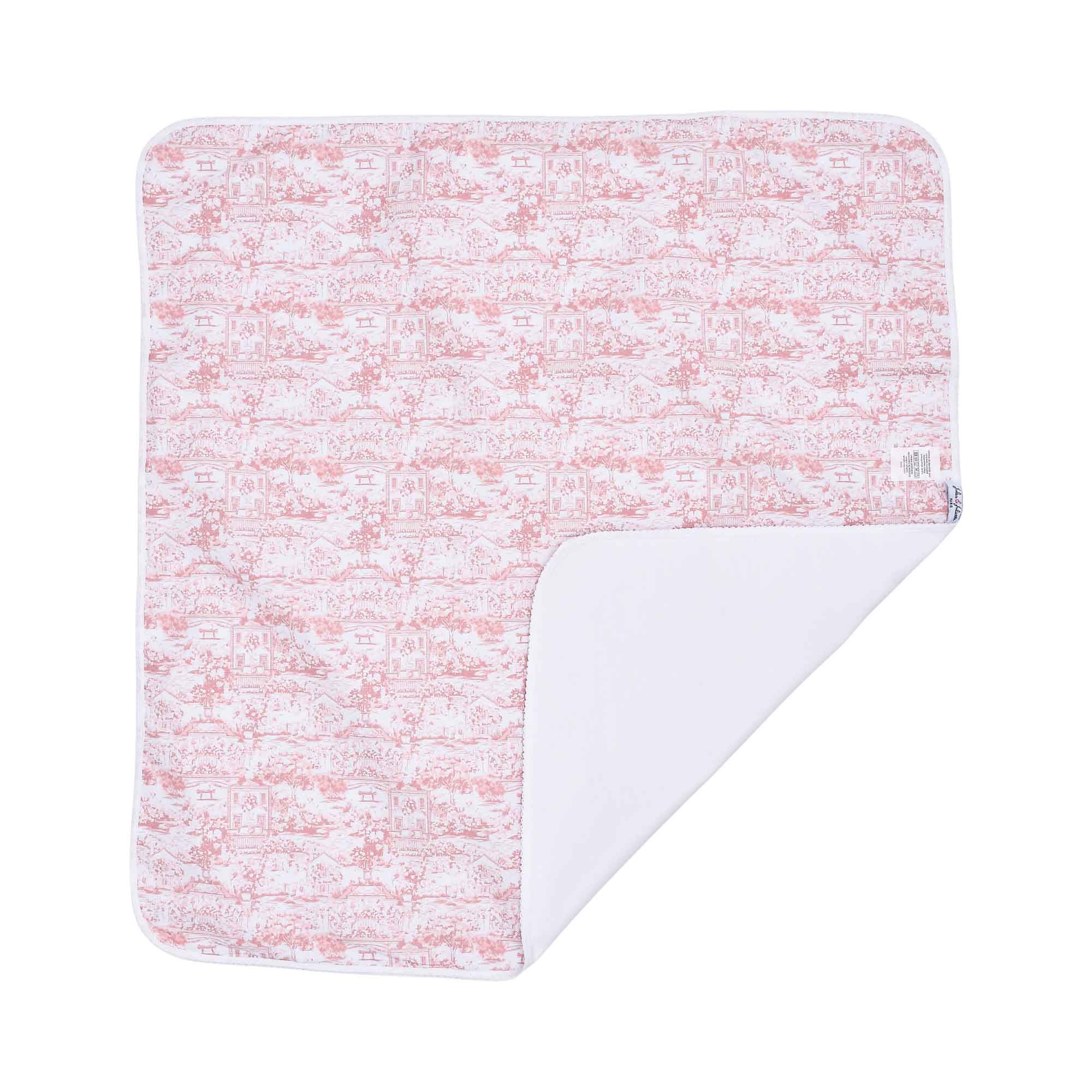 A full, flat view of the square swaddle blanket featuring a rose-pink pastoral Toile de Jouy scene printed on white fabric.