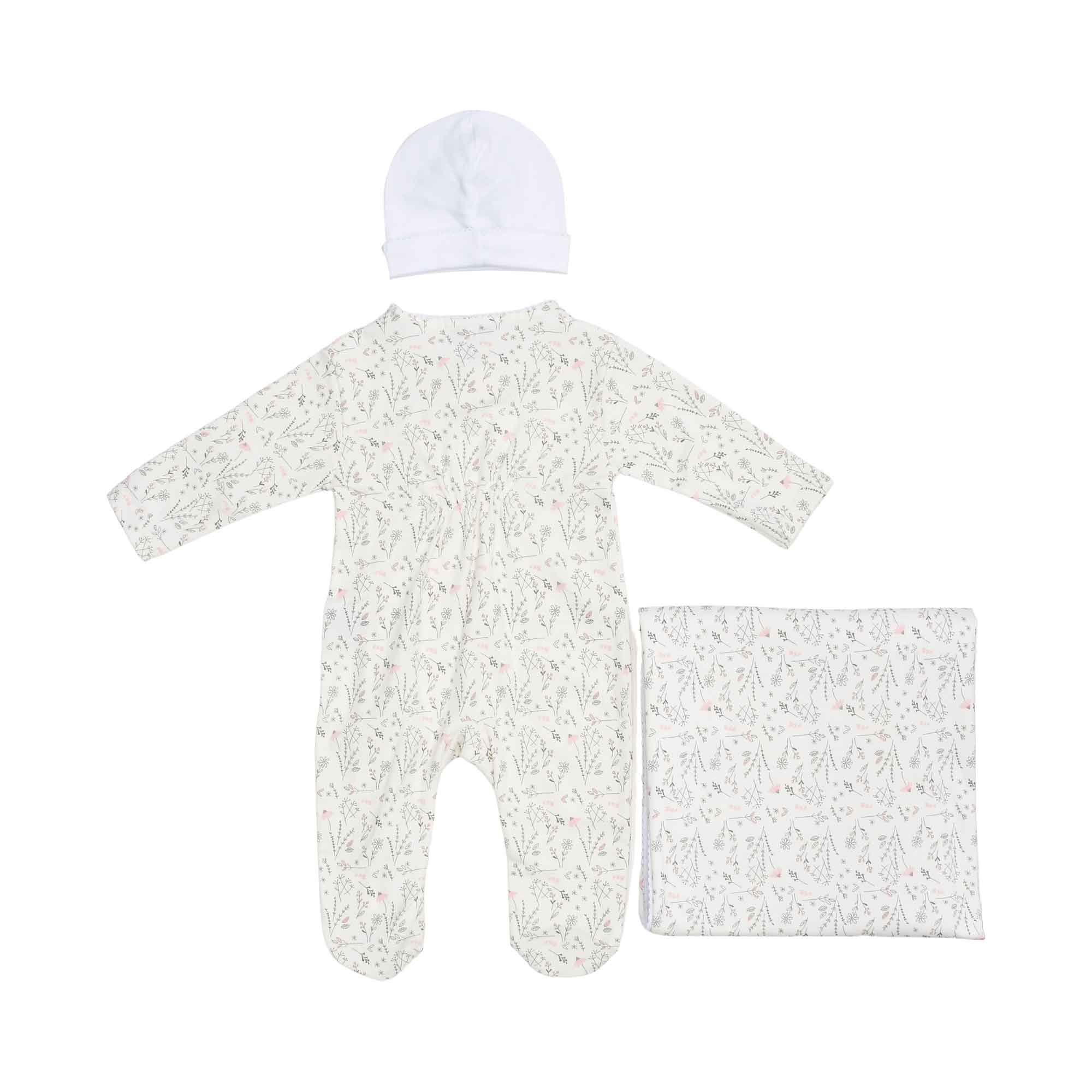 Back view of the botanical print baby sleepsuit, showing the seamless design alongside the white hat and folded wildflower blanket.
