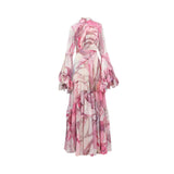 Front studio shot of a pink multi-color abstract print Julytow maxi dress featuring a high neckline, lace chest detail, and tiered ruffle bell sleeves.