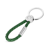 Green braided leather keyring with a silver-toned split ring. Features a silver-toned connector with "SAINT HONORE PARIS" coi