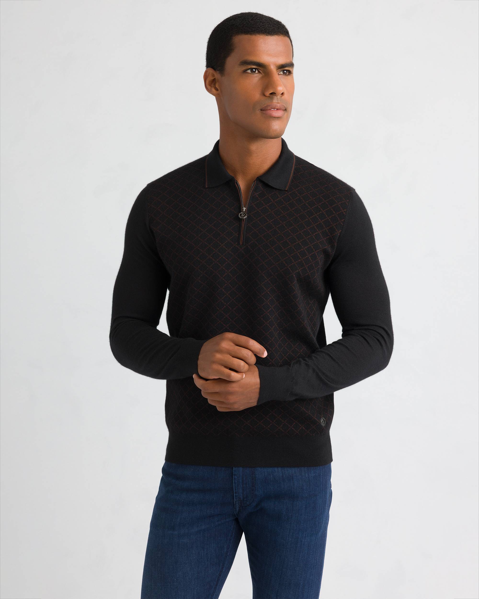 Dark blue knit polo sweater with brown diamond pattern, quarter-zip, and ribbed cuffs.
