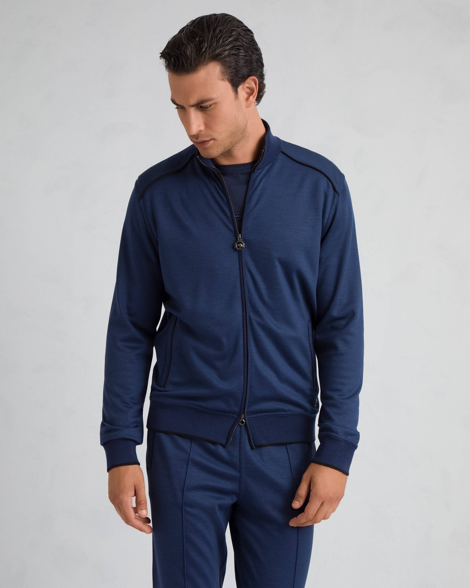 Dark blue men's full-zip knit top with a stand collar, ribbed cuffs and hem, and black contrast piping.