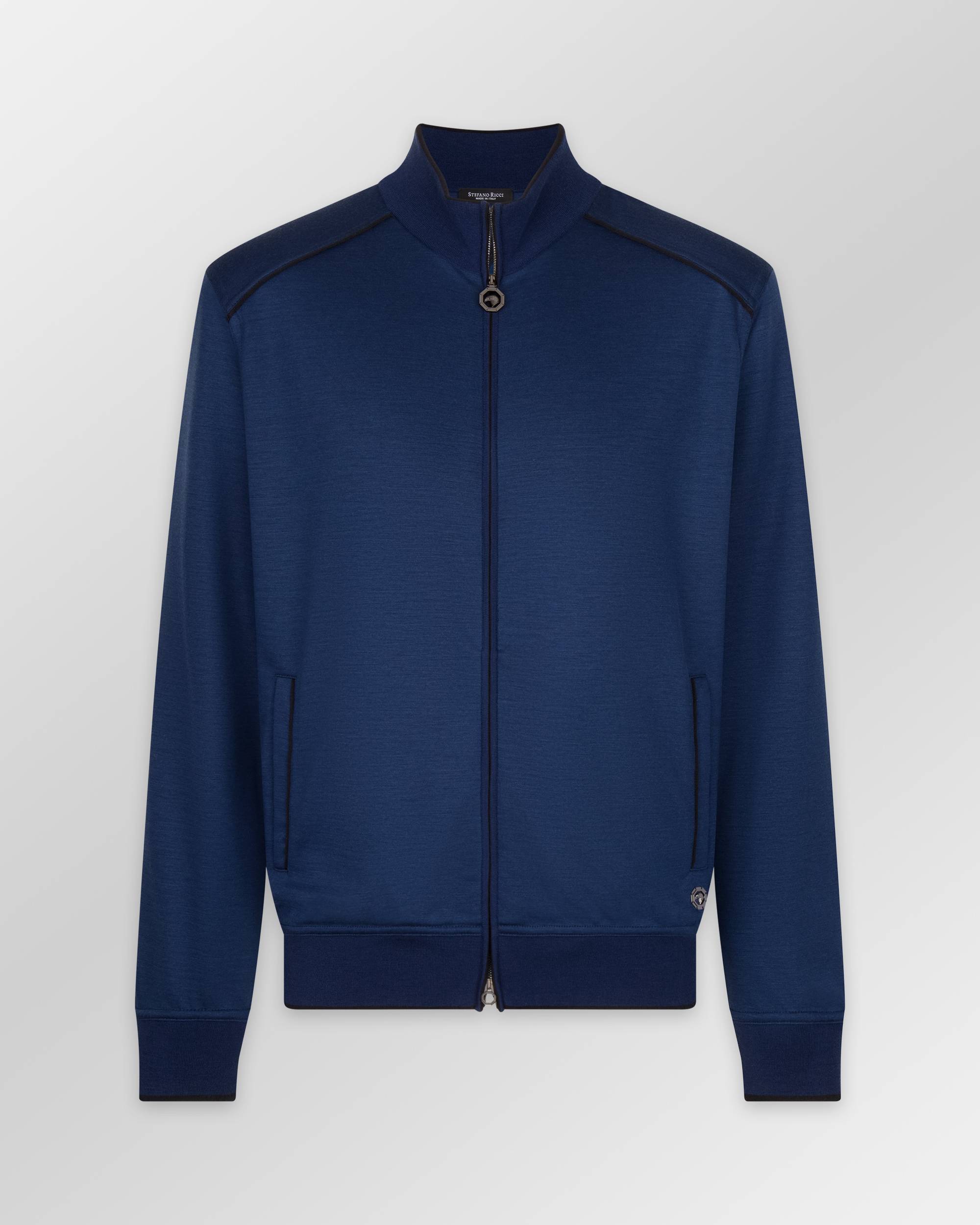 Navy blue full-zip sweater with stand-up collar, black piping on shoulders and pockets, ribbed cuffs and hem, and a circular