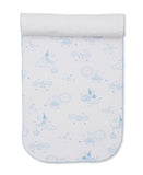 Light blue and white patterned burp cloth with a celestial design of moons, stars, clouds, and suns, and a white terry cloth