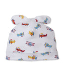 White baby beanie with a knotted bow top, featuring a multicolor print of red, blue, and yellow airplanes.