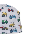 White baby hat with a repeated pattern of red, yellow, blue, and green tractors. The hat features a folded brim.