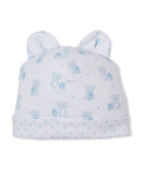 White baby beanie with two rounded ears, featuring an allover print of light blue teddy bears and small stars.
