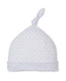 White baby knot hat with a folded brim, covered in a pattern of small light blue stars.