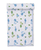 White blanket with an all-over print of blue and green dinosaurs and small green plant motifs, finished with a blue stitched