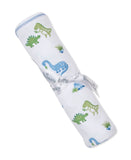 White rolled blanket with green and blue dinosaur print, tied with a white "Kissy Kissy" ribbon. Blue stitched edge.