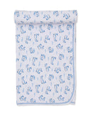 White baby blanket with an all-over blue whale and wave pattern, featuring a blue stitched edge.