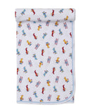 White baby blanket with a repeating pattern of red, yellow, and blue biplanes and helicopters, finished with a light blue tri