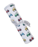 White blanket with a multicolor tractor print, rolled and tied with a light gray "kissy kissy" ribbon.