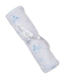 Rolled white blanket with light blue celestial patterns (clouds, stars, suns), light blue scalloped trim, and a white 'Kissy'