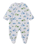 White baby sleepsuit with blue and green dinosaur pattern, long sleeves, integrated feet, and side popper fastenings.