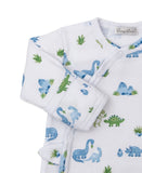 White sleepsuit with blue/green dinosaur, plant, and mountain print. Wrap-style front with snap buttons, long sleeves with ri