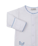 White sleepsuit with blue picot trim on the round neckline and sleeve cuffs. Features a front snap closure and two embroidere