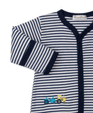 Navy and white striped sleepsuit with navy trim, snap buttons, and embroidered blue and yellow tractors.