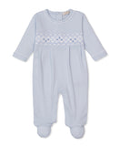 Light blue baby sleepsuit with long sleeves and integrated footies, featuring a white and blue smocked diamond pattern on the
