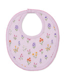 Light pink round bib with multicolor floral print, scalloped pink trim, and a snap closure.