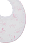 White baby bib with pink scalloped trim, patterned with sleeping pink suns, clouds, moons, and stars.