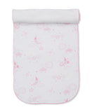 Pink and white burp cloth with a celestial pattern of suns, moons, stars, and clouds, featuring a white terry towelling top.