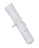 White burp cloth rolled up, with pink scalloped edges and a pattern of pink stars and moons. Tied with a 'kissy kissy' ribbon