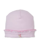 Pink knit baby hat with a ruffled brim and small pink and white floral embroidery.