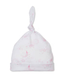 White baby hat with a knotted top and folded brim, patterned with pink outlines of suns, clouds, stars, and moons.