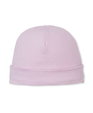Soft pink baby beanie with a folded brim and a central seam on the crown.