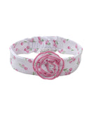 White elastic headband with a pink tulip print and a ruffled pink fabric flower appliqué in the center.